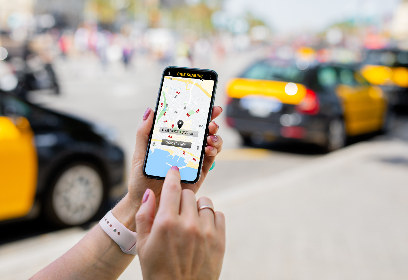 someone holding a smartphone with a rideshare app open ordering a ride to their location