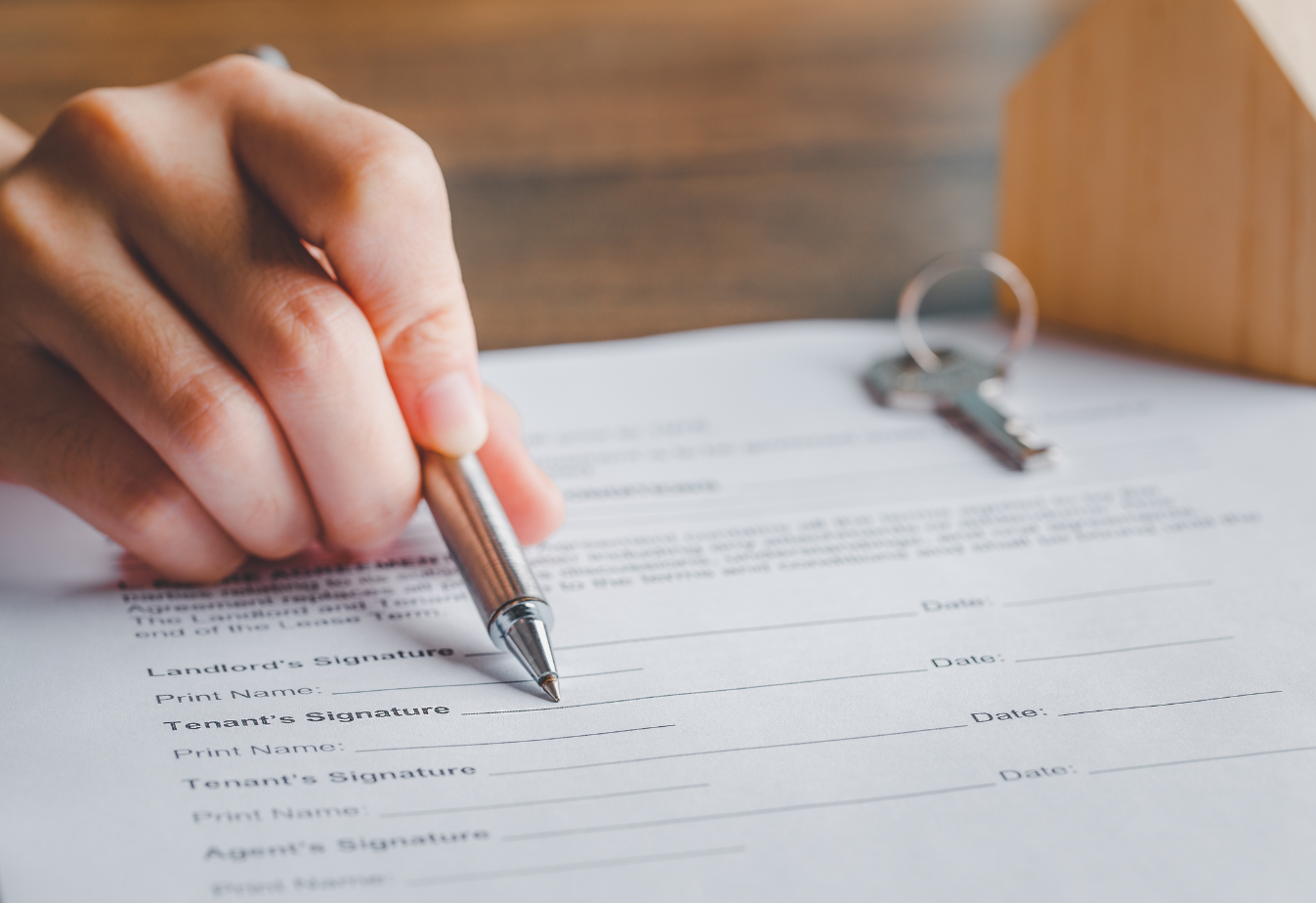 rental agreement with someone pointing a pen to the linese