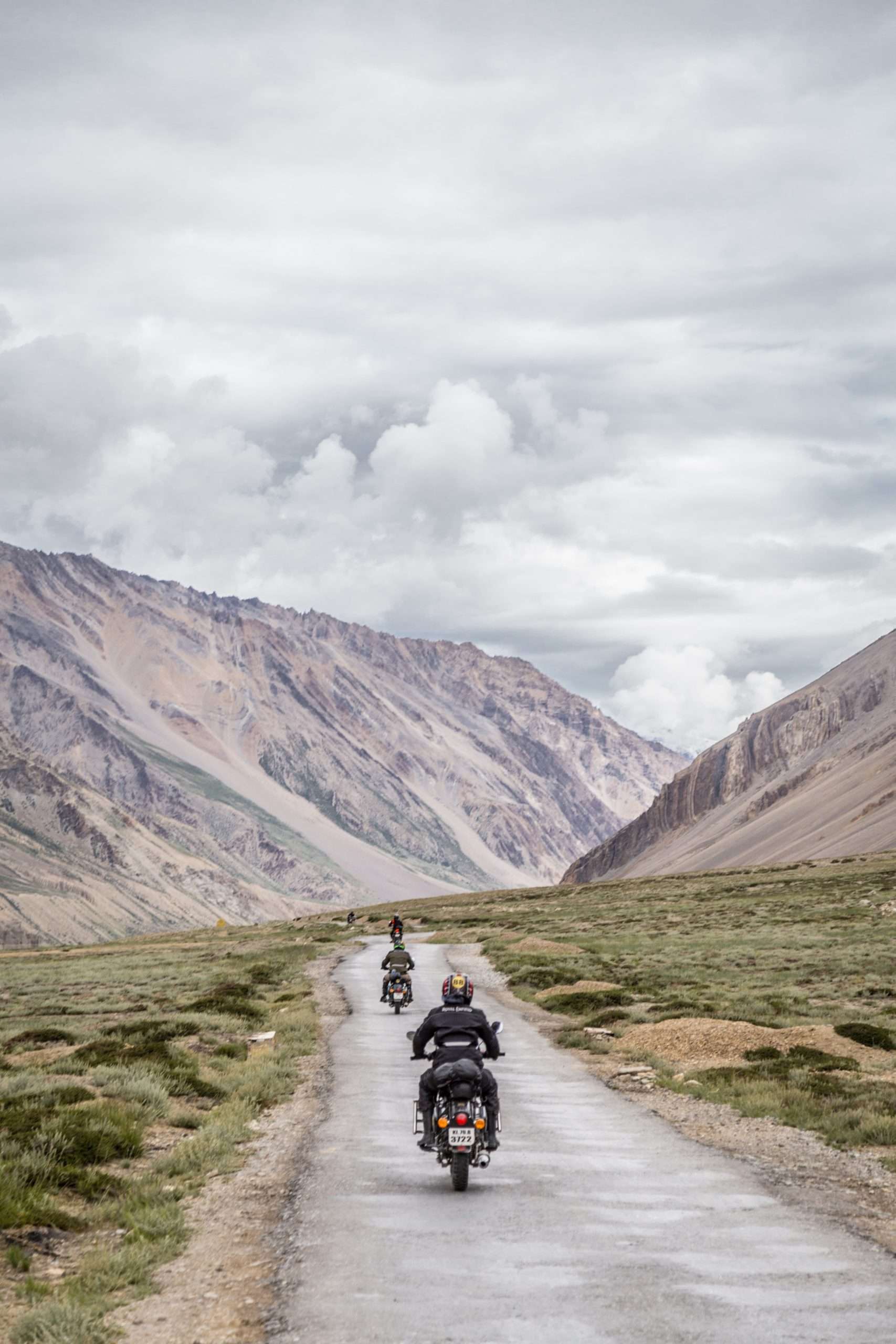two motorcyclists on and open road driving away